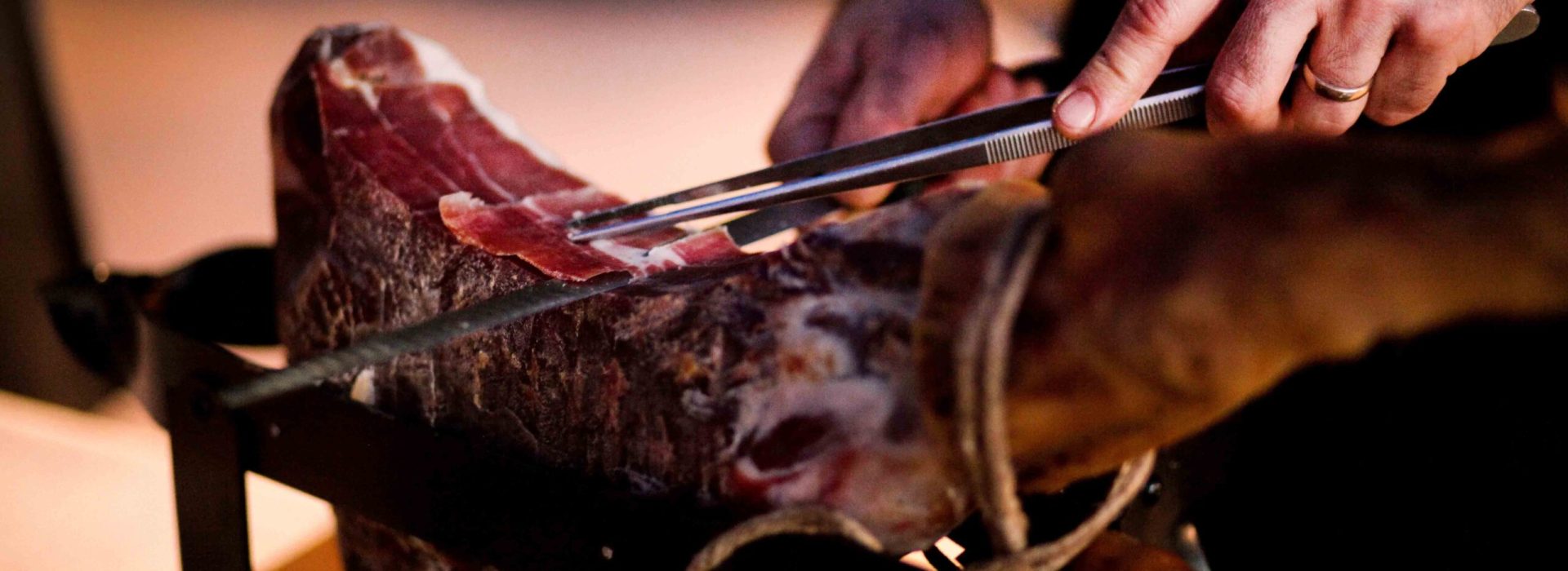 prosciutto Crudo tagliato finemente a fette a mano con un coltel