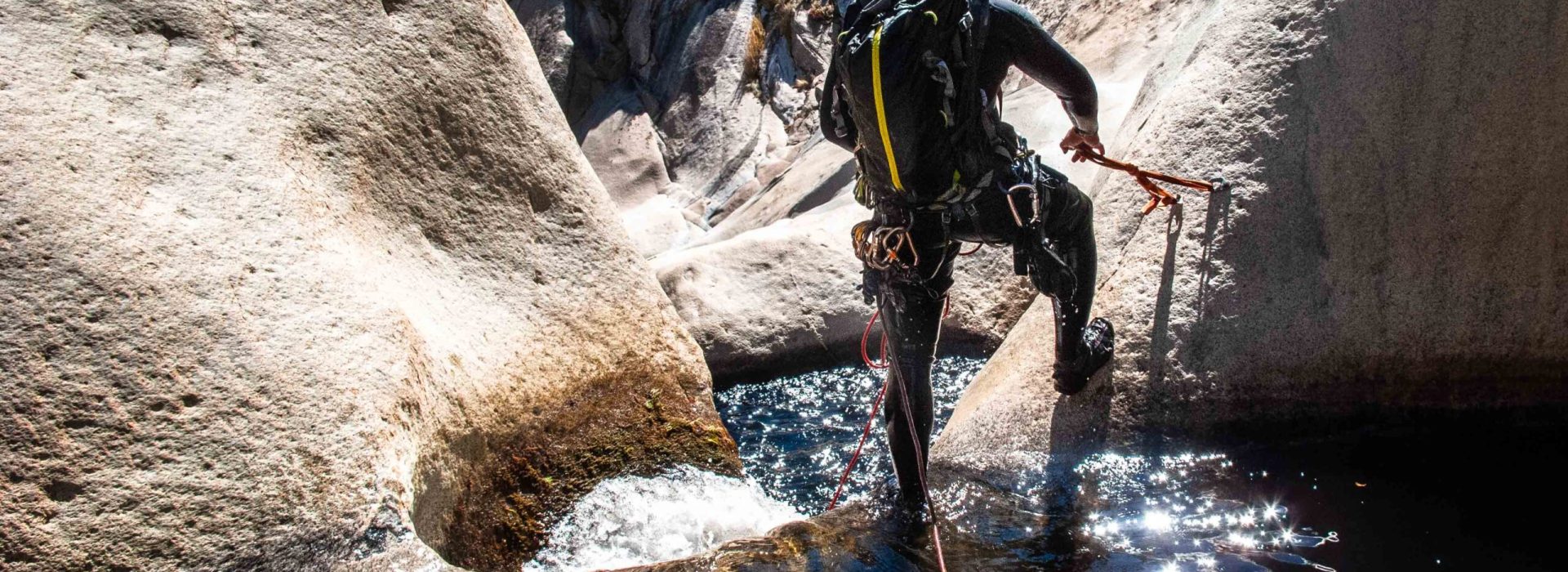 Canyoneer Sets Anchor Above Granite Waterfall