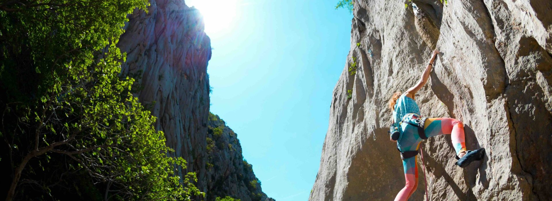 Rock climbing and mountaineering in the Paklenica National Park. A woman overcomes a challenging climbing route on natural terrain. Climber trains on the rocks of Croatia.