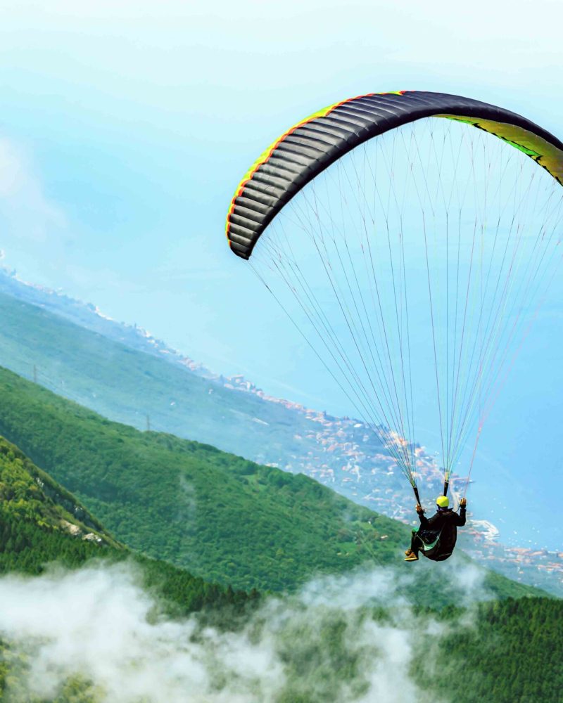Flying paraglider over the Garda Lake in Malcesine,Italy.