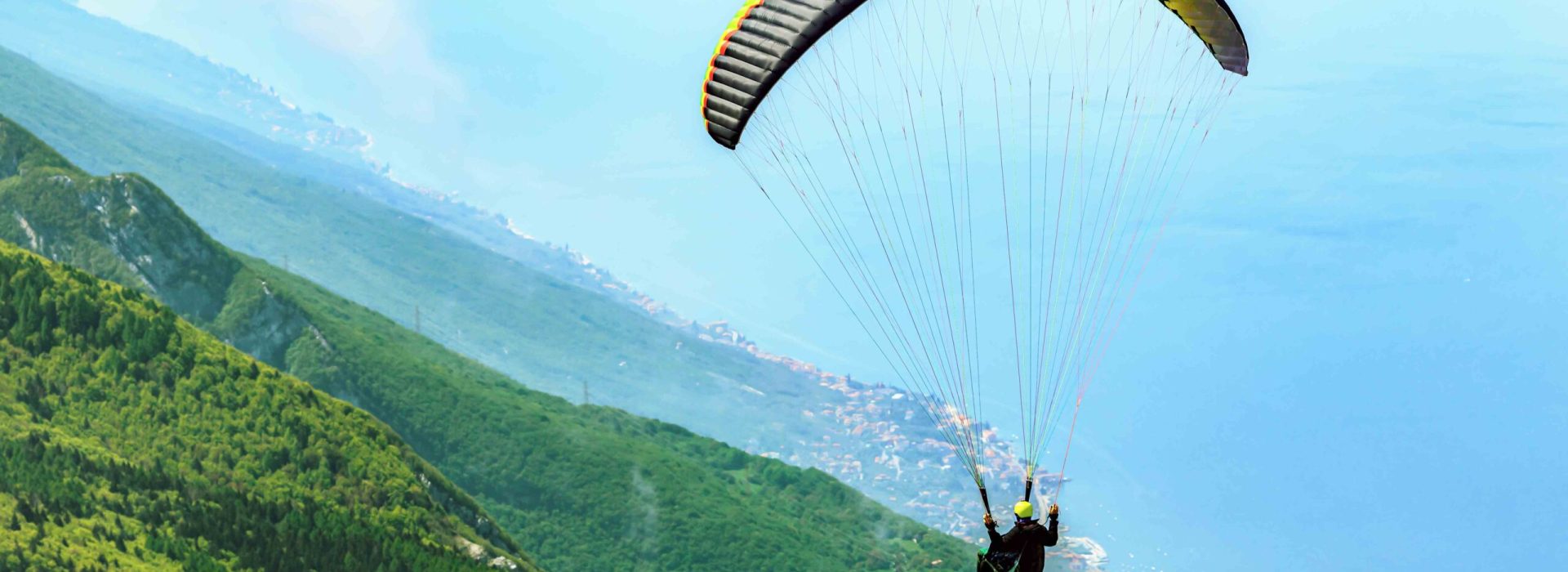 Flying paraglider over the Garda Lake in Malcesine,Italy.