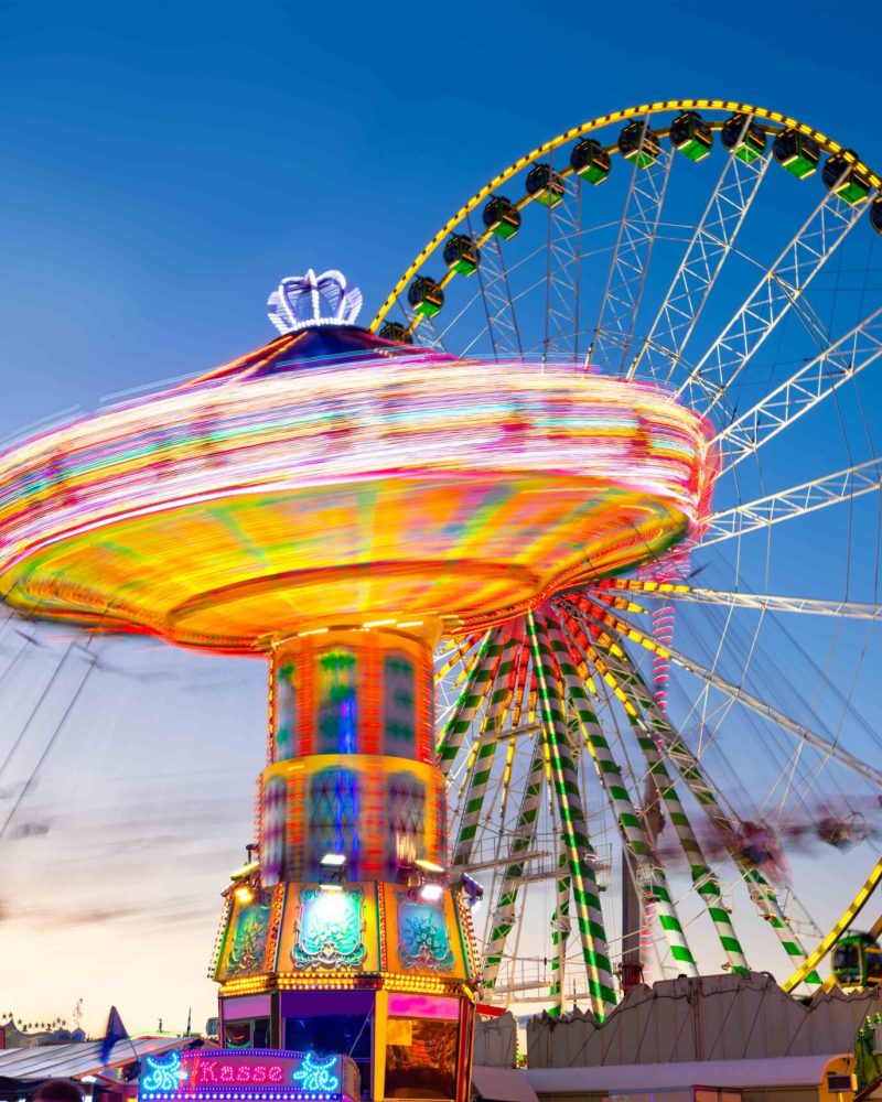 Funfair panorama wiht ferris wheel and carousels on big german f