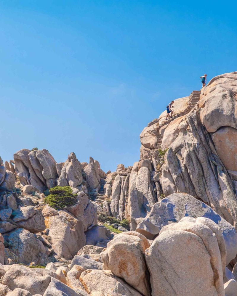 Couple of tourist in the granite landscape at Capo Testa, Santa Teresa Gallura, Gallura area, Sardinia, Italy, Europe