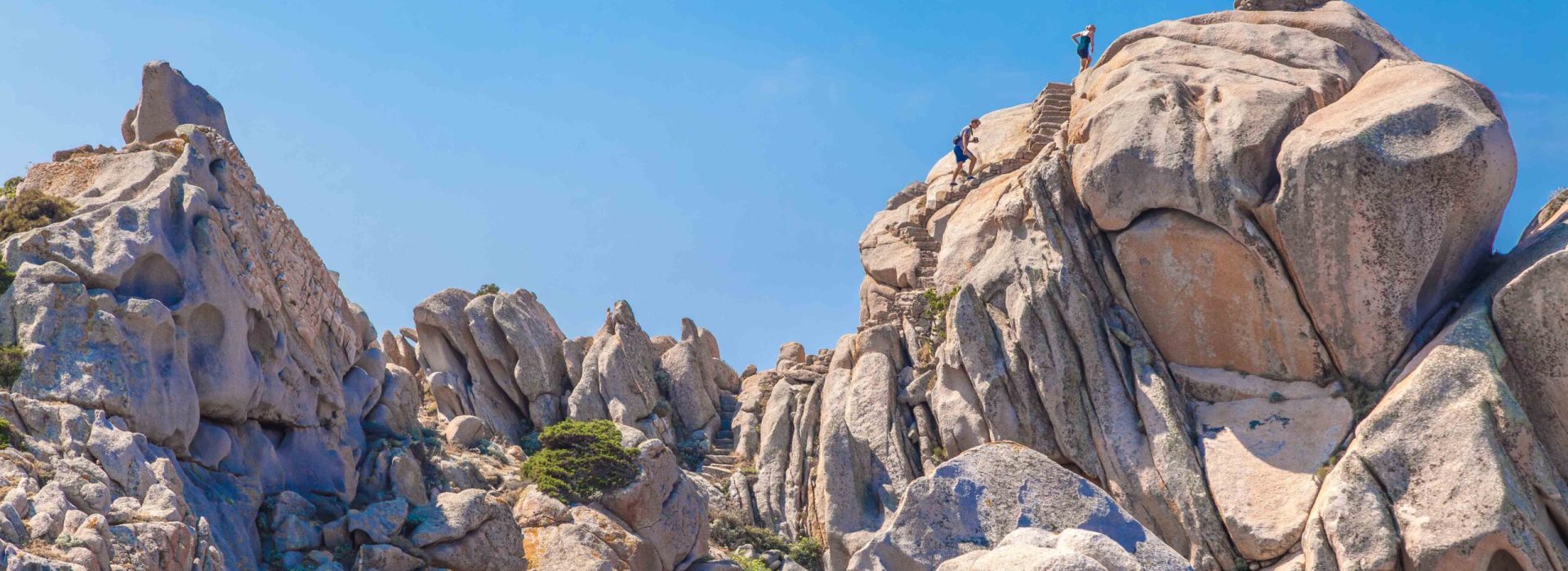 Couple of tourist in the granite landscape at Capo Testa, Santa Teresa Gallura, Gallura area, Sardinia, Italy, Europe
